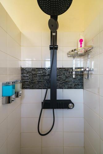 a shower with a blow dryer in a bathroom at Central Penthouse Sky Suite in Nicosia