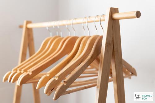 a wooden rack with wooden hangers on it at Angel Cottage - 5 mins drive to Alton Towers! in Alton
