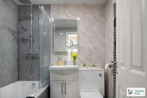 a bathroom with a sink and a shower and a toilet at Angel Cottage - 5 mins drive to Alton Towers! in Alton