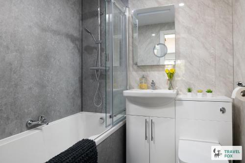 a bathroom with a tub and a sink and a shower at Angel Cottage - 5 mins drive to Alton Towers! in Alton