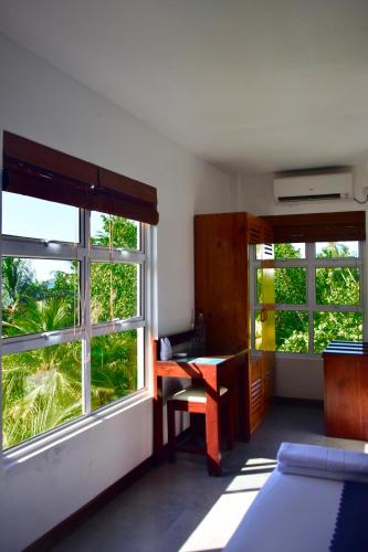 a room with a desk and a window and a desk sidx sidx sidx at Antares Dhangethi & Spa in Dhangethi