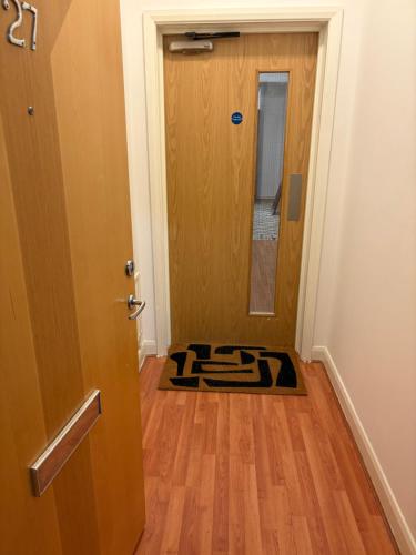 a room with a door and a rug on the floor at 3 Bed Luxury Contractors Apartment, Free Parking, City Centre, Fast WiFi by Opulent Stays in Derby