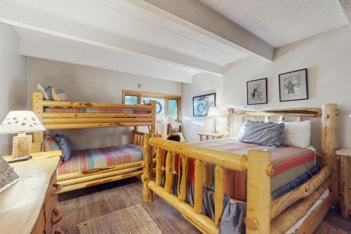 a bedroom with two bunk beds and a desk at Summit House East 113 in Copper Mountain