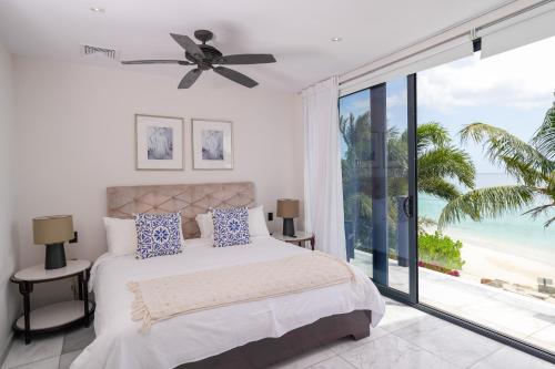 a bedroom with a bed with a view of the ocean at Tamarind Hills Resort & Villas in Johnsons Point