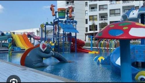 a water park with a playground with a inflatable animal at بورسعيد بورتو سعيد Porto Said شالية فندقي شقة فندقية in Ad Dībah