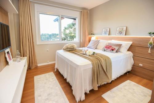 Ένα ή περισσότερα κρεβάτια σε δωμάτιο στο Rosa Edifício Solare Catedral