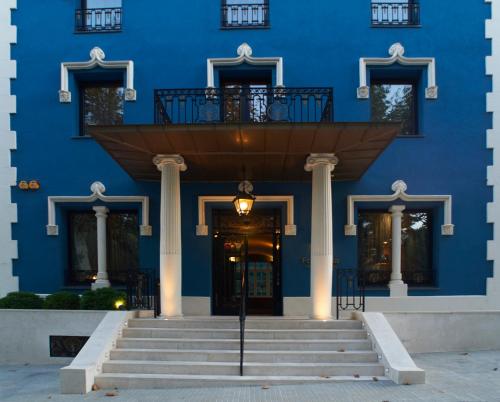 a blue building with stairs in front of it at Balneario Font Vella- Adults Only in Sant Hilari Sacalm