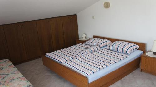 a bedroom with a bed with two pillows on it at Suran Apartments in Pula