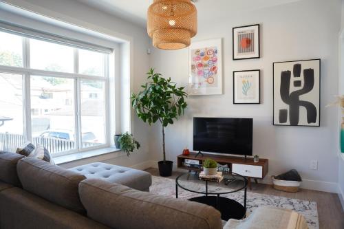 a living room with a couch and a tv at Charming 3BR Home in a Lovely Vancouver Neighborhood in Vancouver