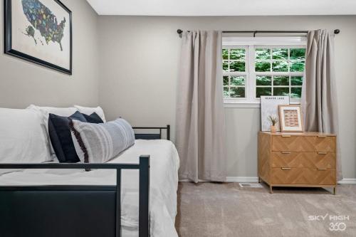 a bedroom with a bed and a window at Creekside Oasis - 5BR Retreat with Pool & Hot Tub in Rogers