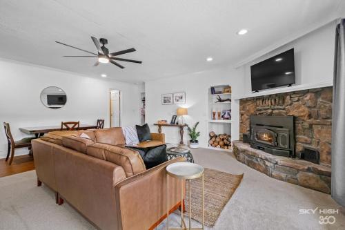 a living room with a couch and a fireplace at Creekside Oasis - 5BR Retreat with Pool & Hot Tub in Rogers
