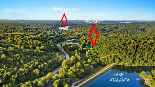 an aerial view of an island in the middle of a forest at Creekside Oasis - 5BR Retreat with Pool & Hot Tub in Rogers