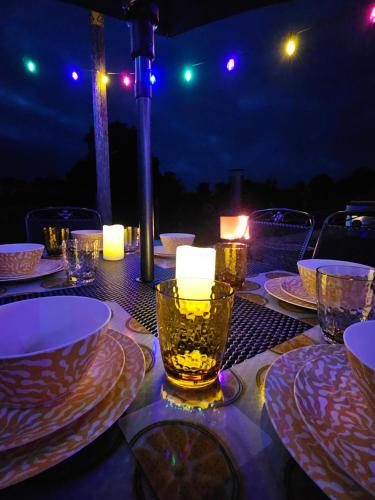 a table with plates and candles on top of it at Red Robin Cottage in Castlewellan