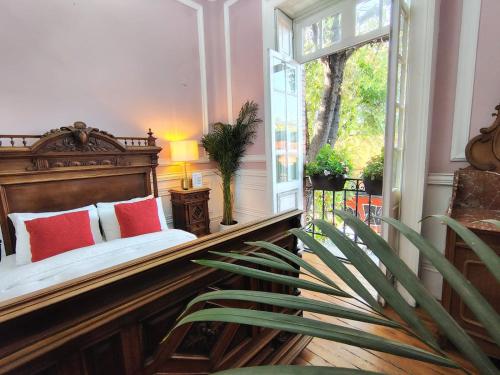 a bedroom with a bed with red pillows and a window at Casa Turin in Mexico City