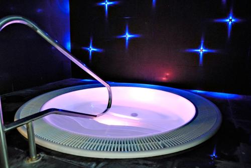 a bathroom with a bath tub with blue lights at Balneario Font Vella- Adults Only in Sant Hilari Sacalm