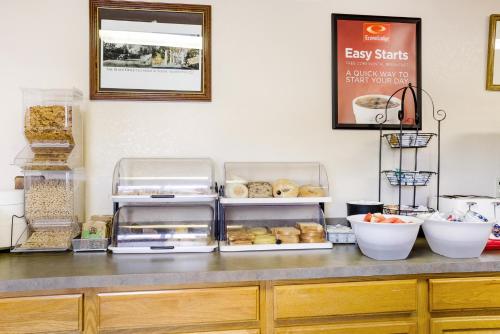 a counter with a bunch of food on it at Econo Lodge, Downtown Custer Near Custer State Park and Mt Rushmore in Custer