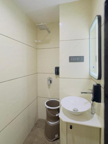 a bathroom with a sink and a toilet at Hotel AERO INN in Ahmedabad
