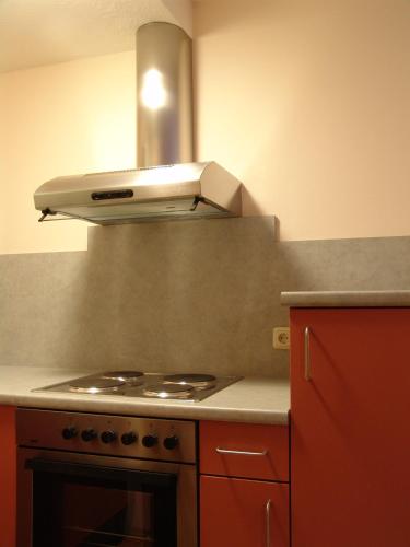 a kitchen with a stove top oven in a kitchen at Gasthof Stern in Vandans