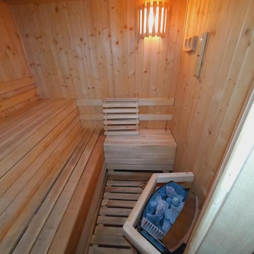 an inside of a wooden sauna with a tub at CHILL-i-Domki in Sandomierz