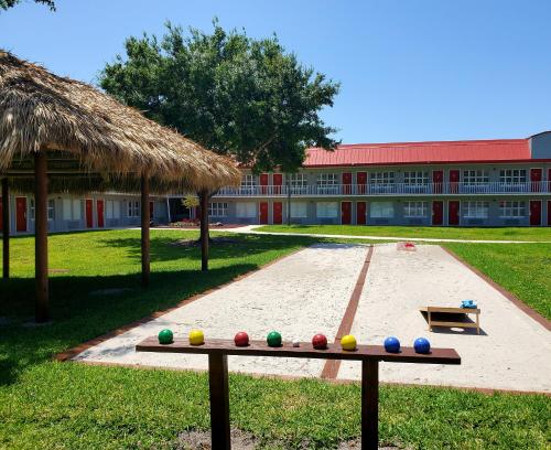 a bench with colorful balls on it in front of a building at Vero Beach Inn & Suites Vero Beach I-95 in Vero Beach