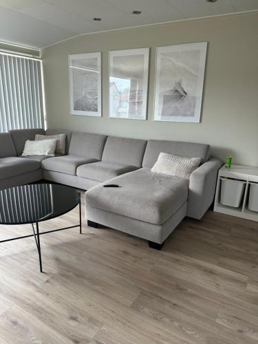 a living room with a couch and a coffee table at Flott bolig på Øvre kleppe med fine solforhold og fin uteplass in Askøy