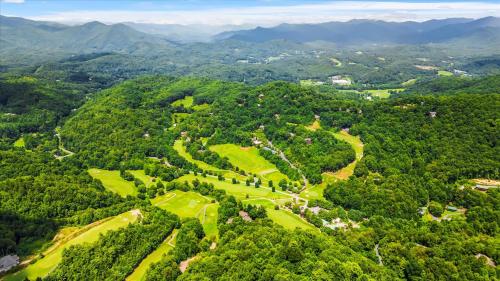 an aerial view of a golf course in the mountains at Sky View - Luxury Mountain Golf Home in Whittier