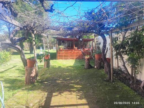 a garden entrance to a house with a pergola at Hostal Fernanda in Santa Cruz