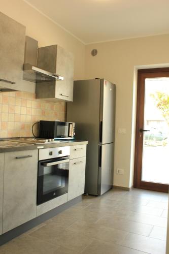 a kitchen with a stainless steel refrigerator at Villa Savi in Bergamo