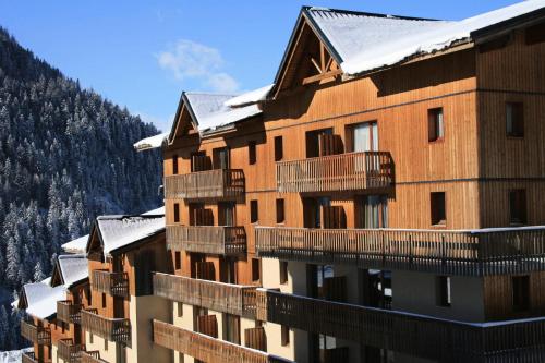 a building with snow on top of it at Résidence Le Cheval Blanc - LE CHEVAL BLANC - CB15 MAE-3124 in Modane