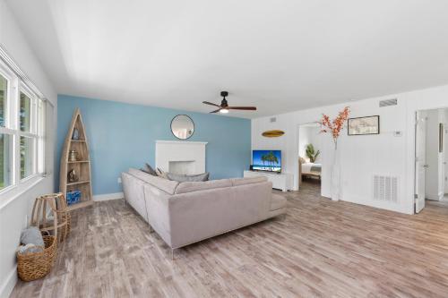 a living room with a couch and a fireplace at Location & Comfort- Coastal Meets Contemporary in Vero Beach