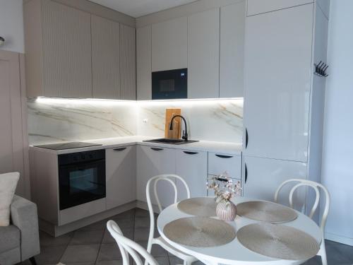 a kitchen with a table and chairs in a room at La Bella Riva in Sarnico