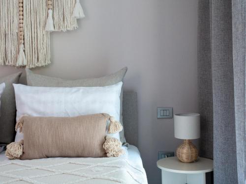a bedroom with a bed with a pillow and a lamp at La Bella Riva in Sarnico