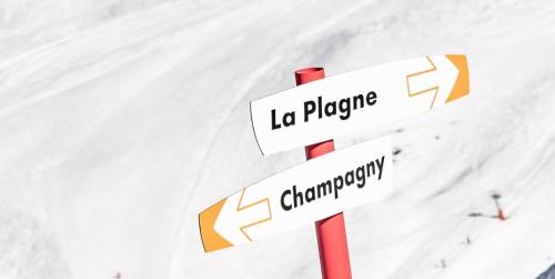two white street signs on a red pole in the snow at Résidence Le Centre - 2 Pièces pour 4 Personnes MAE-3338 in Champagny-en-Vanoise