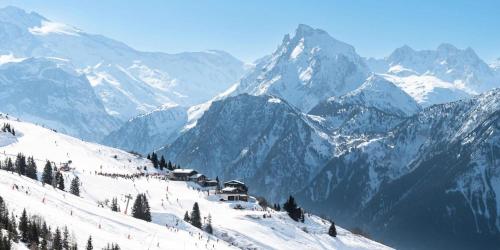 a snow covered mountain with a ski lodge on a slope at Résidence Le Centre - Studio pour 4 Personnes MAE-3340 in Champagny-en-Vanoise