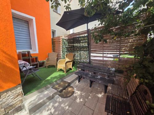 a bench with an umbrella on a patio at Apartments Angels o k b in Altenburg