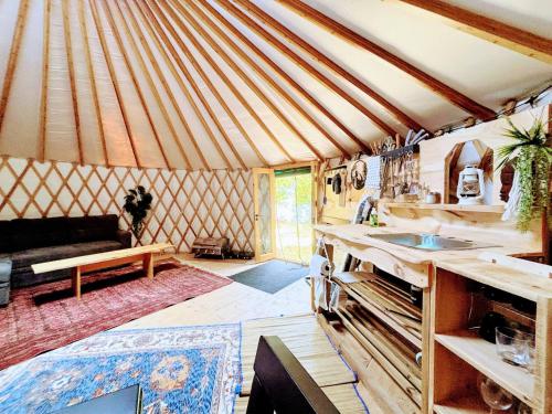 a room with a yurt with a sink and a couch at Dreaming SkyLake Yurt Waterfront in Red Bay