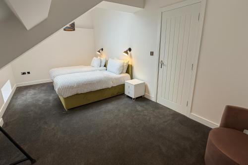 a small bedroom with a bed and a door at Kehoe's Penthouse Apartment in Manchester
