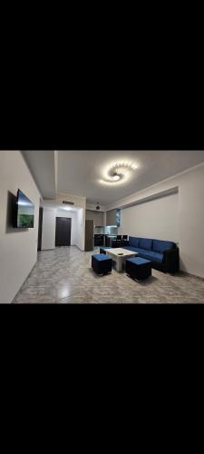 a large living room with blue couches and a table at Alvina SJS in Tsaghkadzor