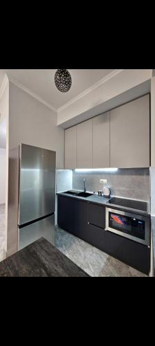 a kitchen with a sink and a stainless steel refrigerator at Alvina SJS in Tsaghkadzor