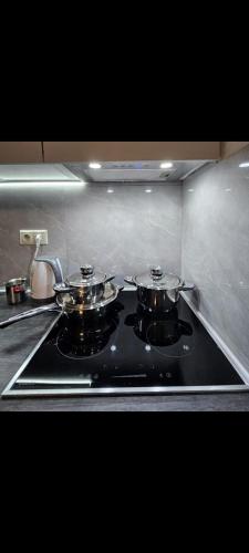 two pots and pans on a stove in a kitchen at Alvina SJS in Tsaghkadzor