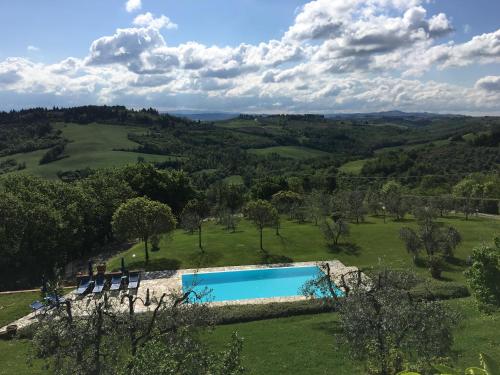 an aerial view of a swimming pool in a green field at Podere Casanova in Montespertoli