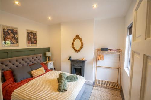 a bedroom with a bed and a fireplace at The Narrow House - Victorian house bursting with character & parking in Chester