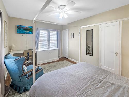 a bedroom with a bed and a chair and a desk at Blue bird House- 6 Rooms for extended room stay in Brownfield