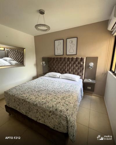 a bedroom with a large bed and two mirrors at Alojamiento Familiar Premium - Con Piscinas, Jacuzzi y Capacidad 13 - By Molca Travel in Armenia
