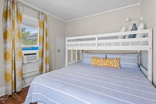 a bedroom with a bed and a bunk bed at Historic Home with Modern Upgrades - Prime Downtown Location in Fort Pierce