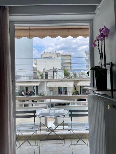 a table and chairs in a room with a window at Basic Stay in Xanthi