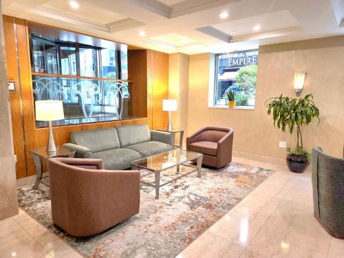 a lobby with a couch and chairs and a table at San Carlos Hotel New York in New York