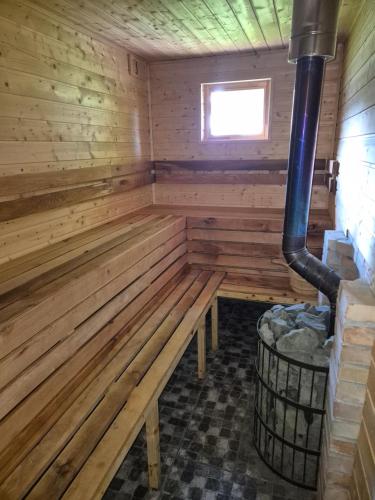 a wooden sauna with a bench in a room at Apartamenty pod Orzechem in Kościerzyna