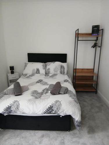 a bedroom with a bed with a black and white comforter at Lyndon house in Beaufort