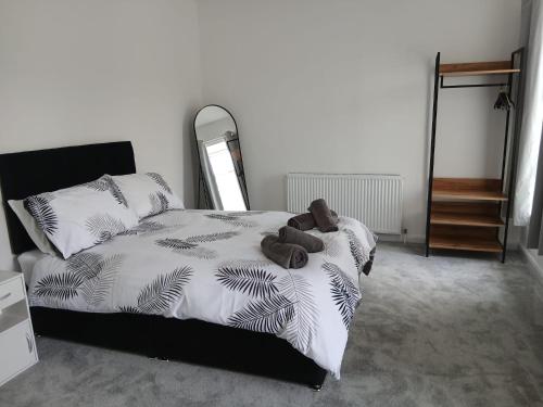 a teddy bear laying on a bed in a bedroom at Lyndon house in Beaufort